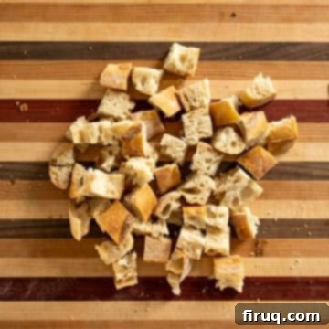 Rustic Tuscan Panzanella 4 Cubed day-old bread, ready for drying, on a clean surface.