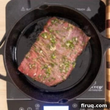 Vibrant Chimichurri Steak Tacos 10 Searing steak on cast iron pan.