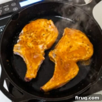Pork Chops with Bourbon Peach Glaze 9 Glazing pork chops in a cast iron.