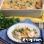 Creamy Chicken Suiza Pasta Bake 8 A top-down view of the golden-brown Chicken Suiza Pasta Bake in a white casserole dish