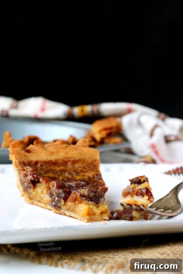 Ready-to-eat Butter Tart Pie Slice Slice of butter tart pie and a fork on a plate, ready to be eaten.