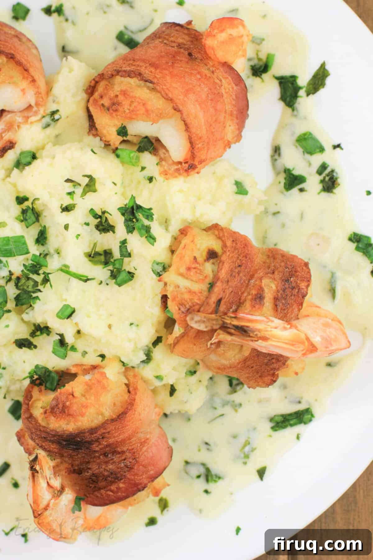 Crab Filled Shrimp with Bacon 3 crab stuffed shrimp arranged around mashed potatoes on white plate