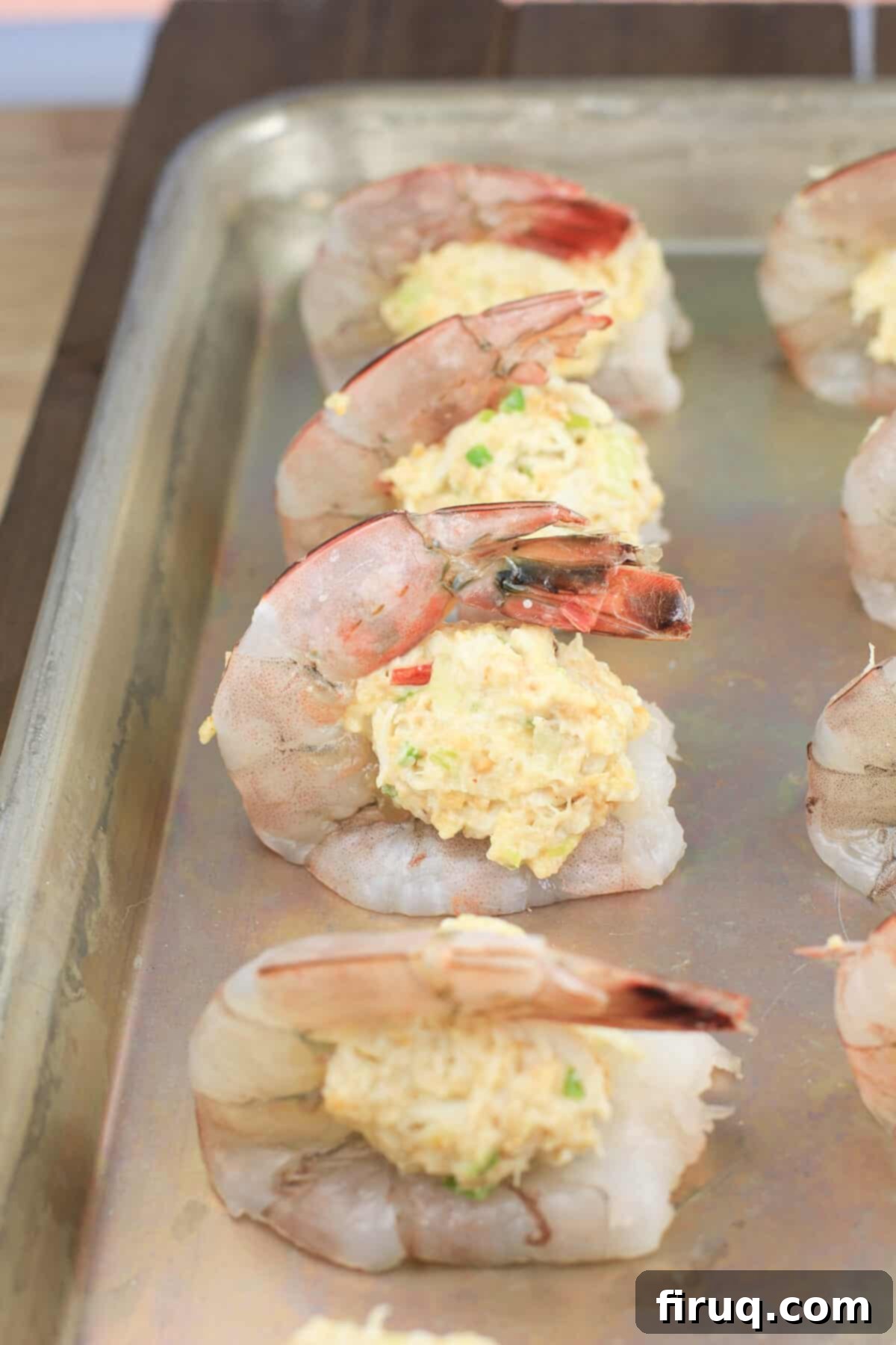 Crab Filled Shrimp with Bacon 6 crab stuffing mounded on butterflied shrimp on a baking sheet