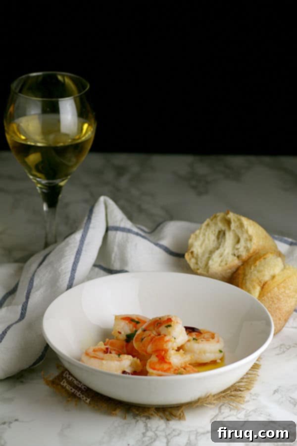 Mediterranean Garlic Shrimp Close-up of golden brown Mediterranean Garlic Shrimp in a white bowl, garnished with fresh parsley.