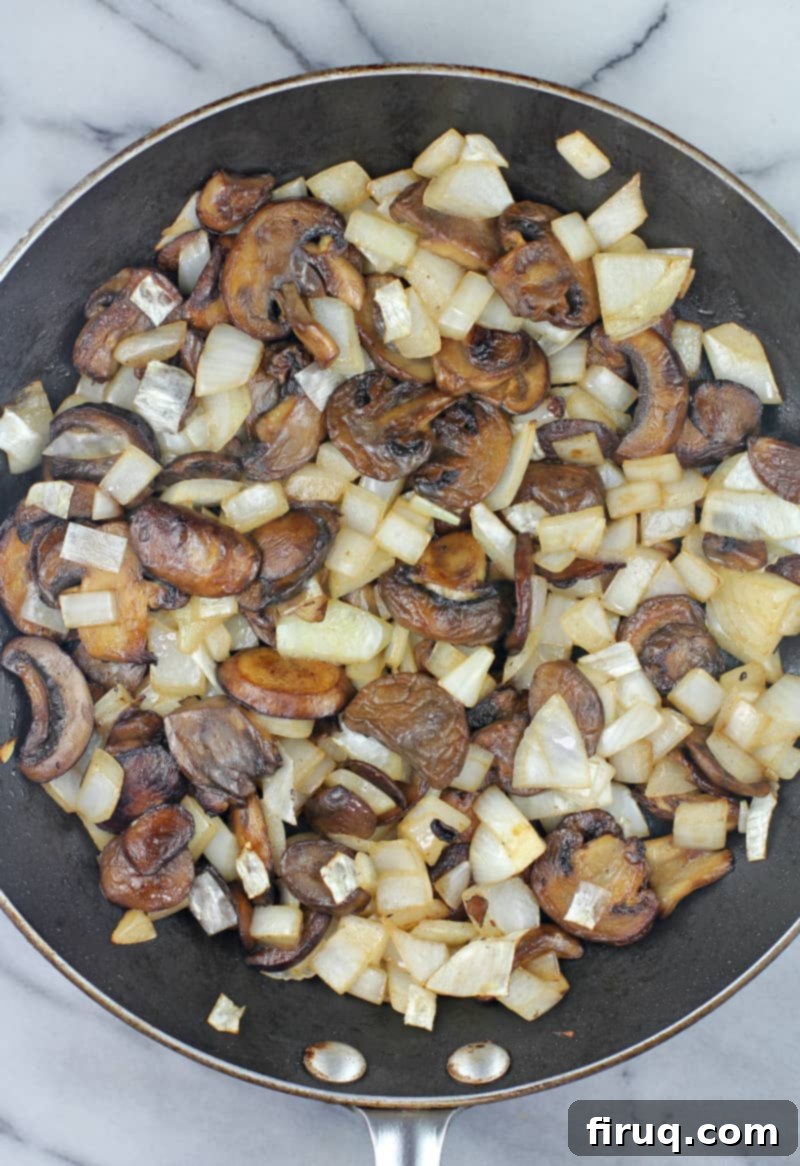 Creamy Asparagus Bake 6 Sautéed mushrooms and golden-brown onions cooked in a skillet, ready for the casserole.