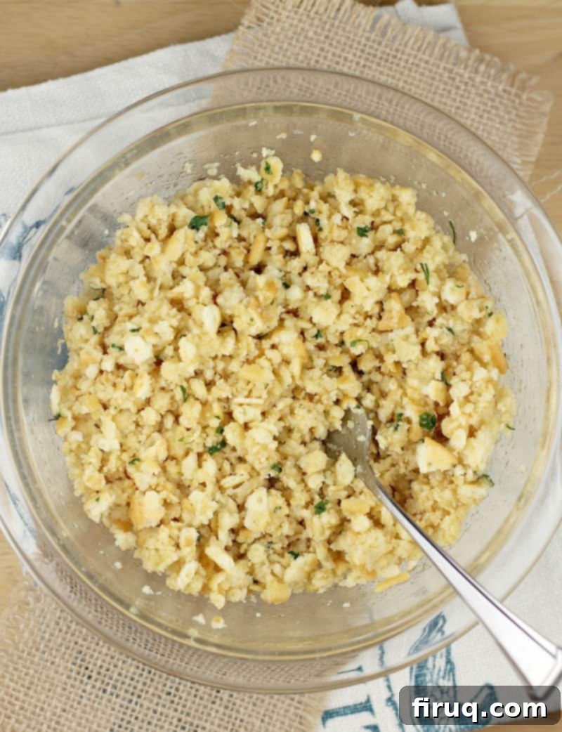 Classic Boston Baked Cod 3 clear glass bowl with a spoon and the assembled topping mixture