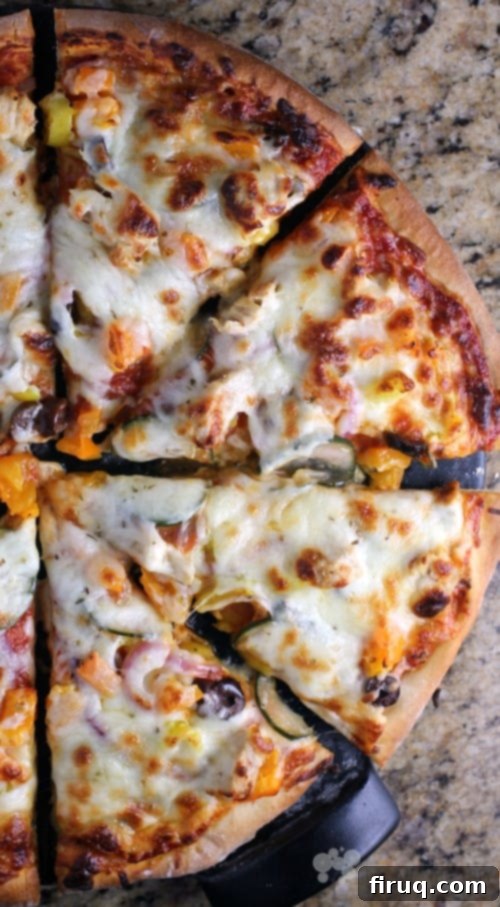 Mediterranean Chicken Gyro Pizza 7 A freshly baked Chicken Gyro Pizza, perfectly golden brown and ready to be sliced. This Mediterranean-inspired pizza is a delightful twist on a classic.