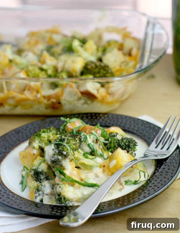 Cheesy Broccoli Bake 3 broccoli cheese casserole on a rimmed dish with fork, casserole dish in the background