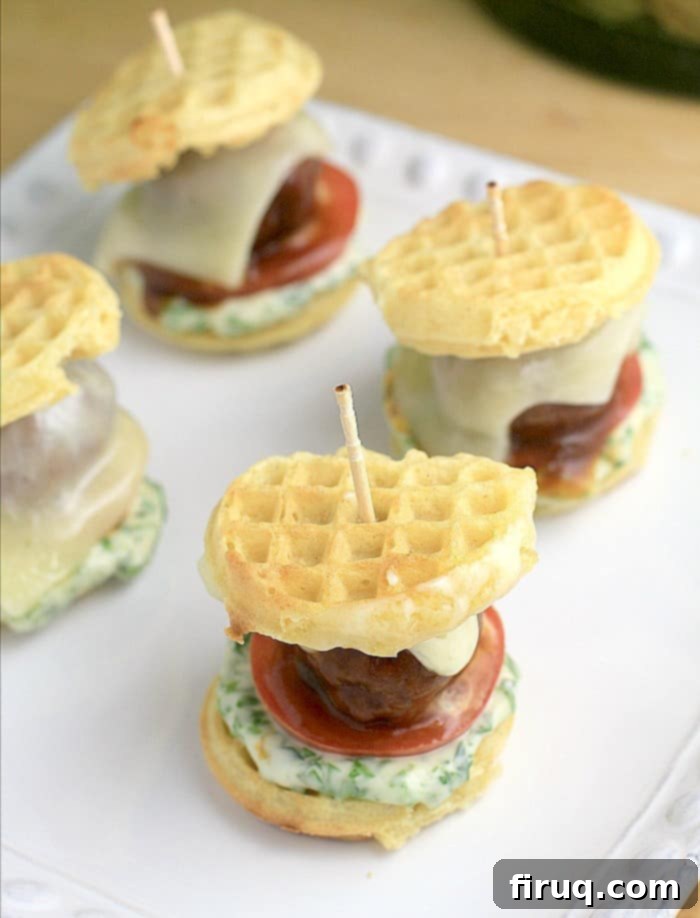 Smoky BBQ Meatball Waffle Sliders 2 assembled sliders on a white dish with a toothpick in each