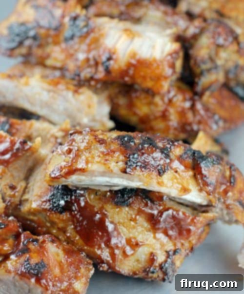 Brewmaster's Baby Back Ribs 3 Close-up of succulent Beer Barbecue Baby Back Ribs glistening with sauce