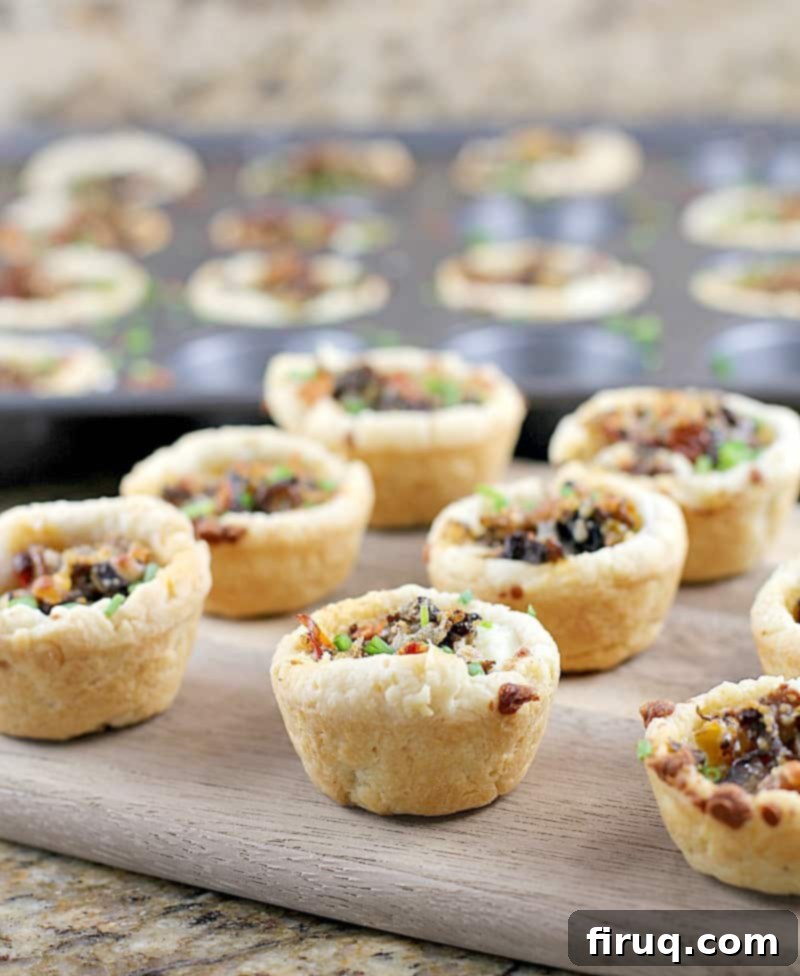 Savory Tuscan Mushroom Ricotta Tartlets 7 Tuscan Mushroom Ricotta Mini Tarts topped with mushroom blend and Parmesan cheese, ready for baking