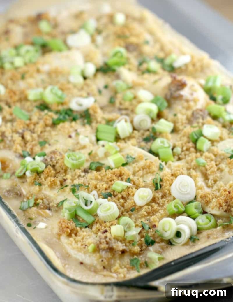 Cheesy Beer and Sausage Pierogi Bake! Potato pierogi pillows and sausage baked in a cheesy beer sauce, this easy pierogi casserole using frozen pierogis is a weeknight must-make. #pierogies #casserole #beer #recipes Cheesy Beer and Sausage Pierogi Bake