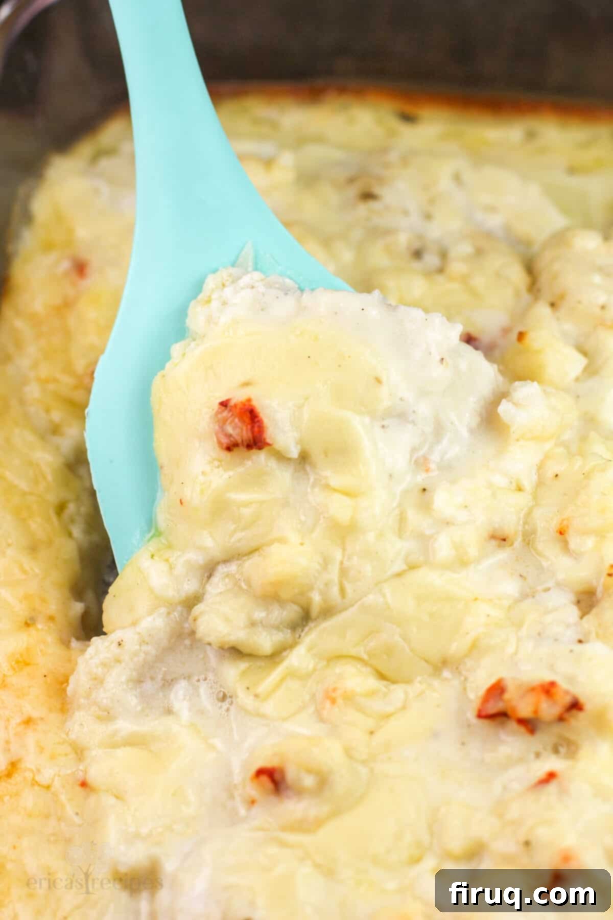 Oven-Baked Haddock, Lobster-Kissed 9 blue spatula scooping casserole