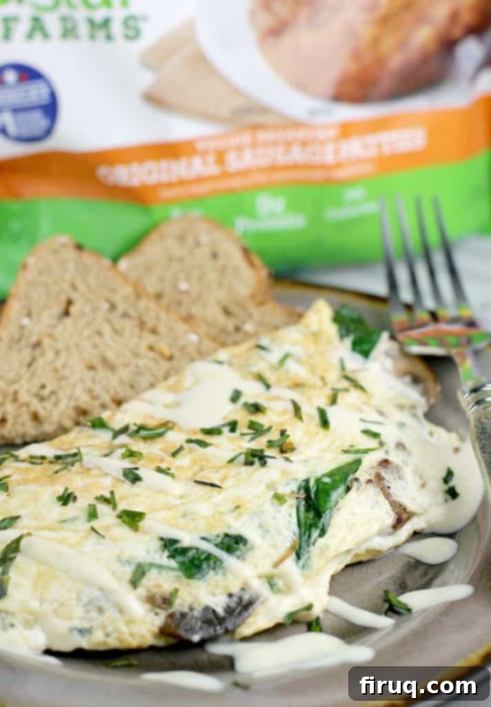 Plant-Powered Omelet with Savory Sausage, Spinach, and Mushrooms 10 side view finished omelet recipe, Morningstar packaging in the background