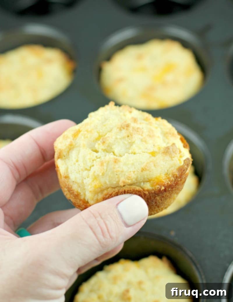 Guilt-Free Cheddar Bay Biscuits 2 Hand holding a perfectly baked, golden-brown keto cheddar bay biscuit
