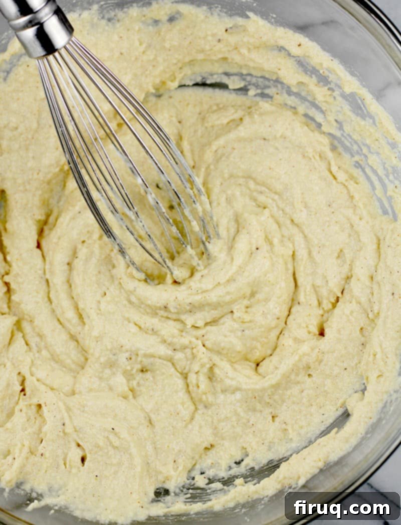 Guilt-Free Cheddar Bay Biscuits 7 Biscuit batter with a whisk, before the shredded cheddar cheese has been added
