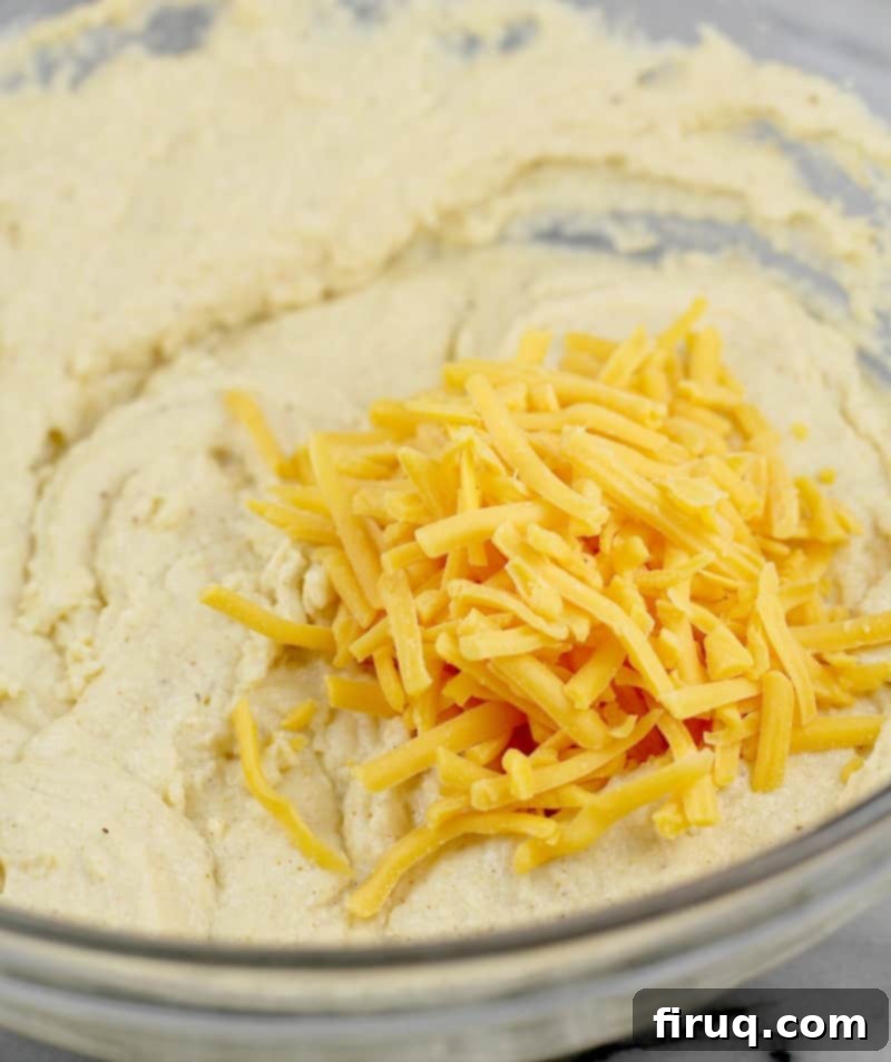 Guilt-Free Cheddar Bay Biscuits 8 Shredded sharp cheddar cheese sprinkled on top of the biscuit batter, ready to be mixed in