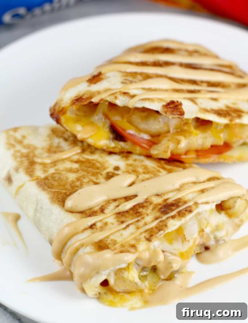 Loaded Burger Fry Quesadilla 2 finished quesadilla, close view with burger sauce drizzled over