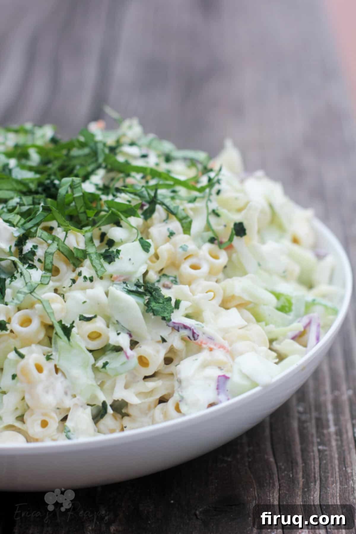 Creamy Slaw Macaroni Medley 2 Coleslaw Pasta Salad in a white bowl, side view, on a rustic wooden table