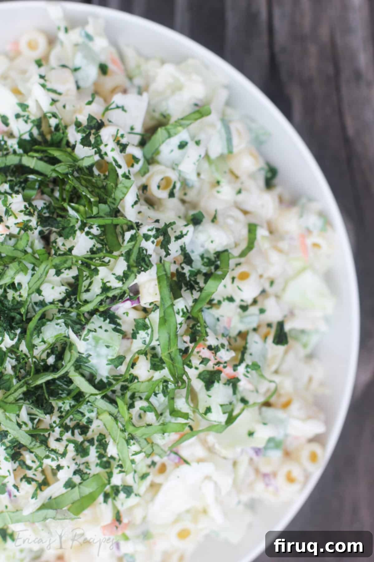 Creamy Slaw Macaroni Medley 4 Prepared coleslaw pasta salad in a white bowl on a weathered wood background