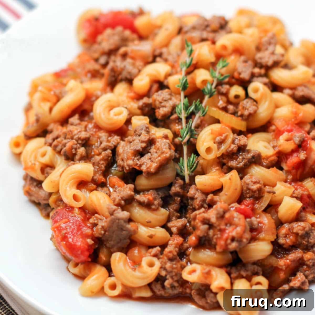 Goulash My Way 2 prepared goulash on white dish topped with small sprig of thyme