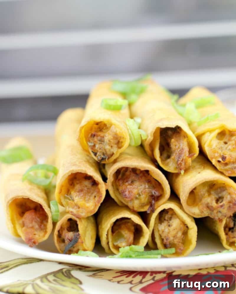 Crispy Air Fryer Pulled Pork Taquitos 9 close up view of air fryer taquitos cut in half to show the cheesy pulled pork filling