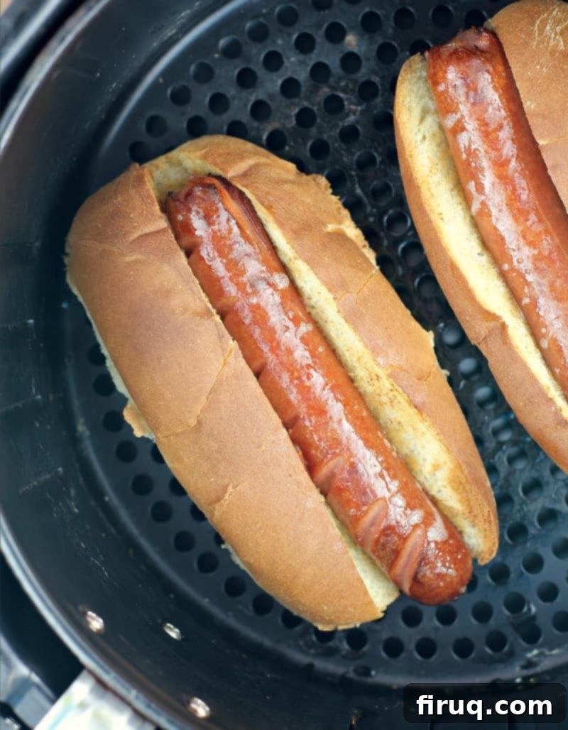 Air Fryer Hot Dogs: Crispy Perfection with Sweet Pepper Relish 8 hot dog in a bun in an air fryer basket
