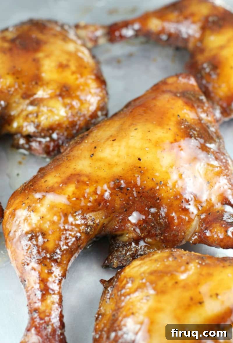 Sweet & Smoky Maple Bourbon Chicken 3 glazed smoked chicken quarter on a bake sheet