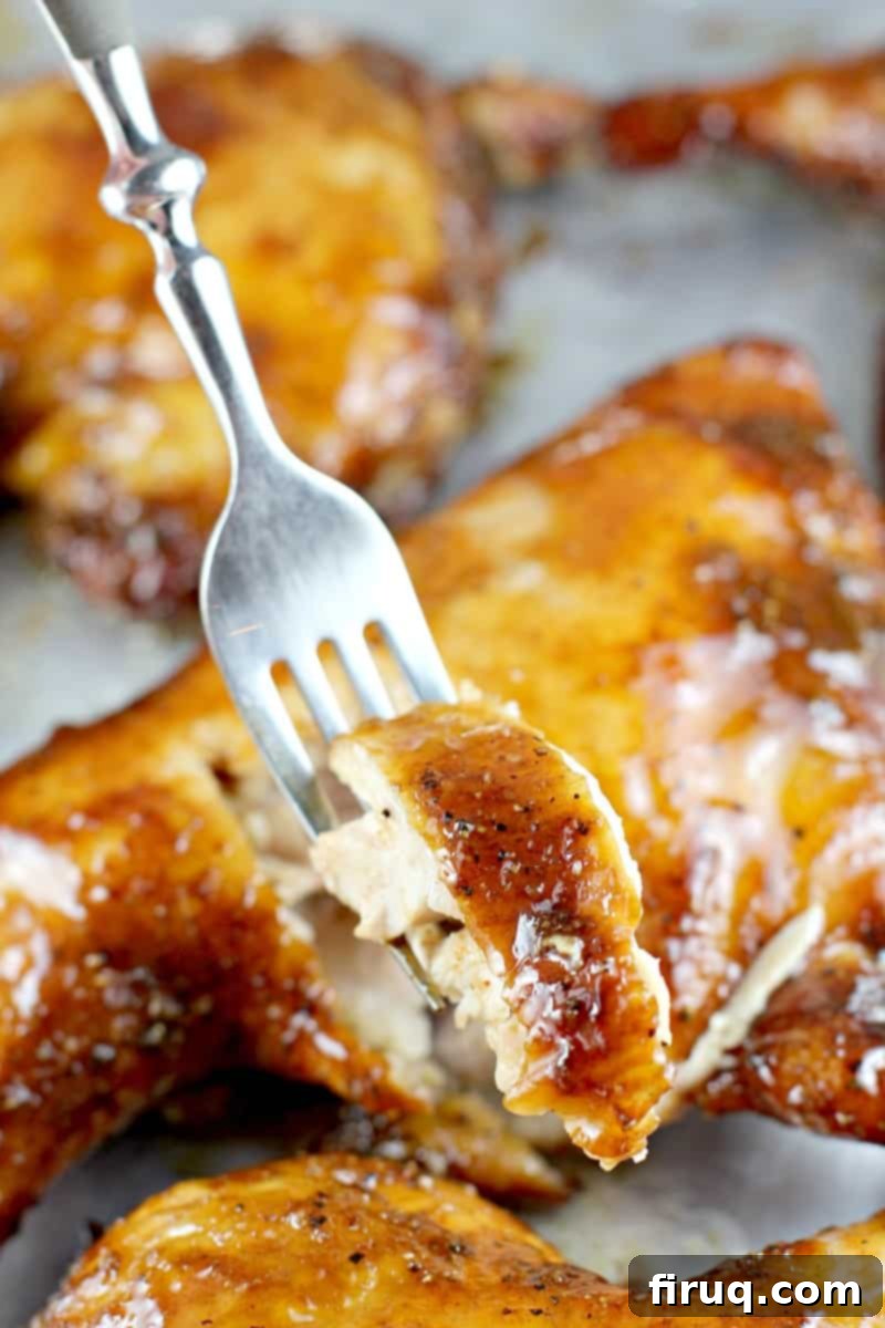 Sweet & Smoky Maple Bourbon Chicken 8 fork holding a bite of chicken; chicken quarters in the background