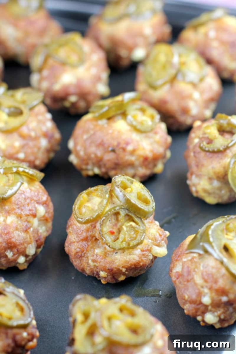 Smoky Sausage Bites 11 smoked sausage balls topped with jalapenos on metal pan