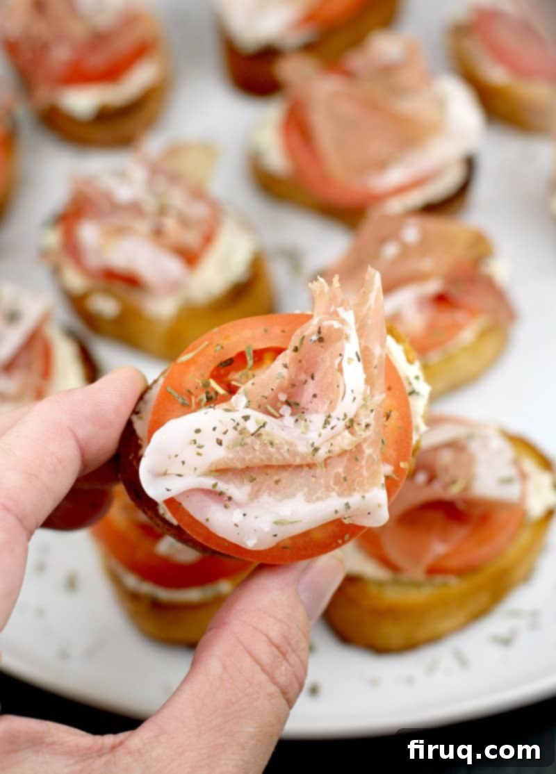 Crispy Prosciutto Crostini 11 hand holding a crostini