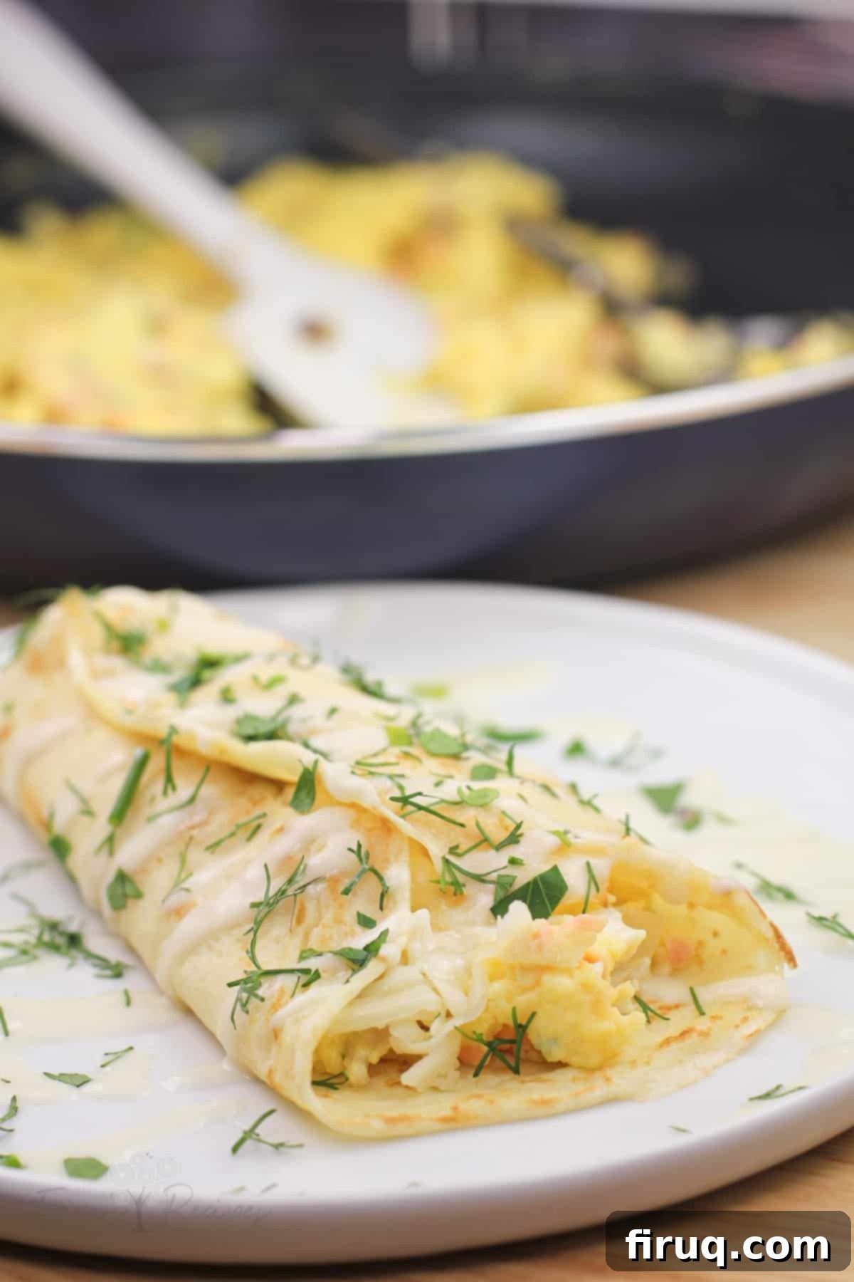 Silken Salmon Crepe Embrace 14 prepared crepe on white plate with skillet in background