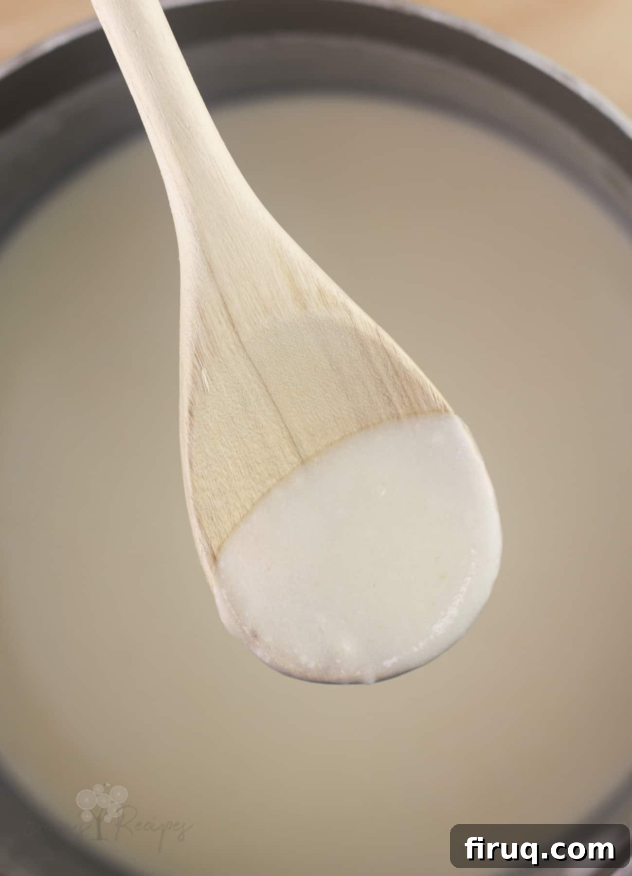 Silken Salmon Crepe Embrace 5 wood spoon with sauce to show thickness