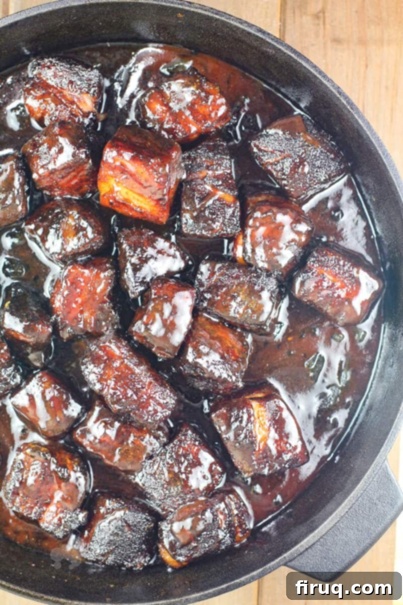 Smoky Glazed Pork Belly Bites 2 Perfectly glazed pork belly burnt ends in a cast iron pan, ready to be served
