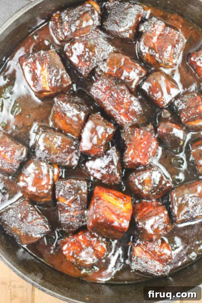 Smoky Glazed Pork Belly Bites 13 Finished pork belly burnt ends glistening with glaze in a cast iron pan