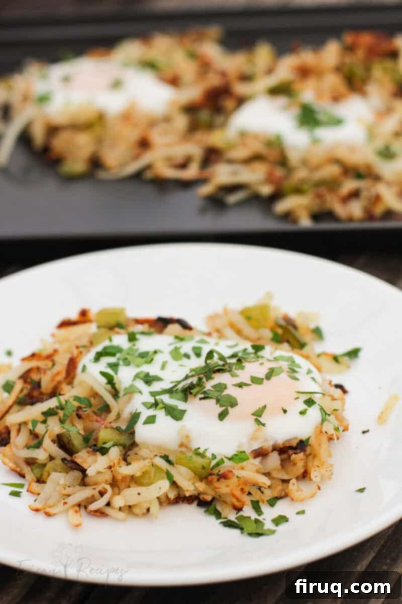 Sizzling Griddle Hash 3 finished recipe on white plate with unbroken egg atop hash browns