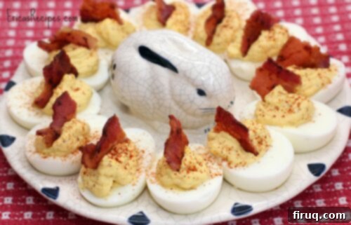 Zesty Stuffed Eggs 7 deviled eggs on platter with bacon on each