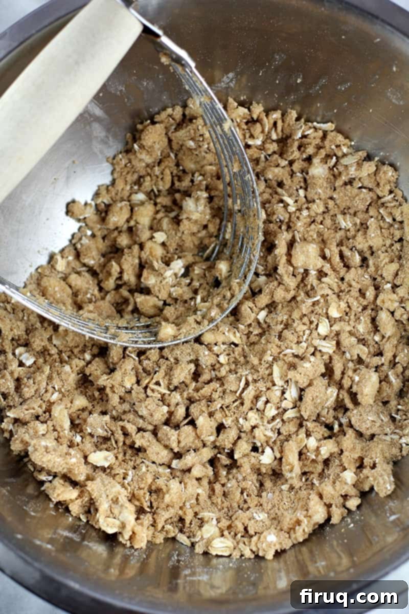 Individual Apple Crisp Pies 5 bowl with streusel mix and a pastry cutter