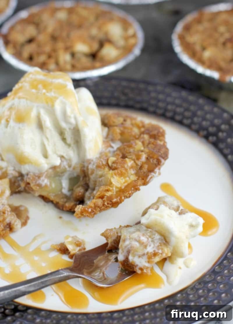 Individual Apple Crisp Pies 9 fork on a plate with apple crisp and ice cream