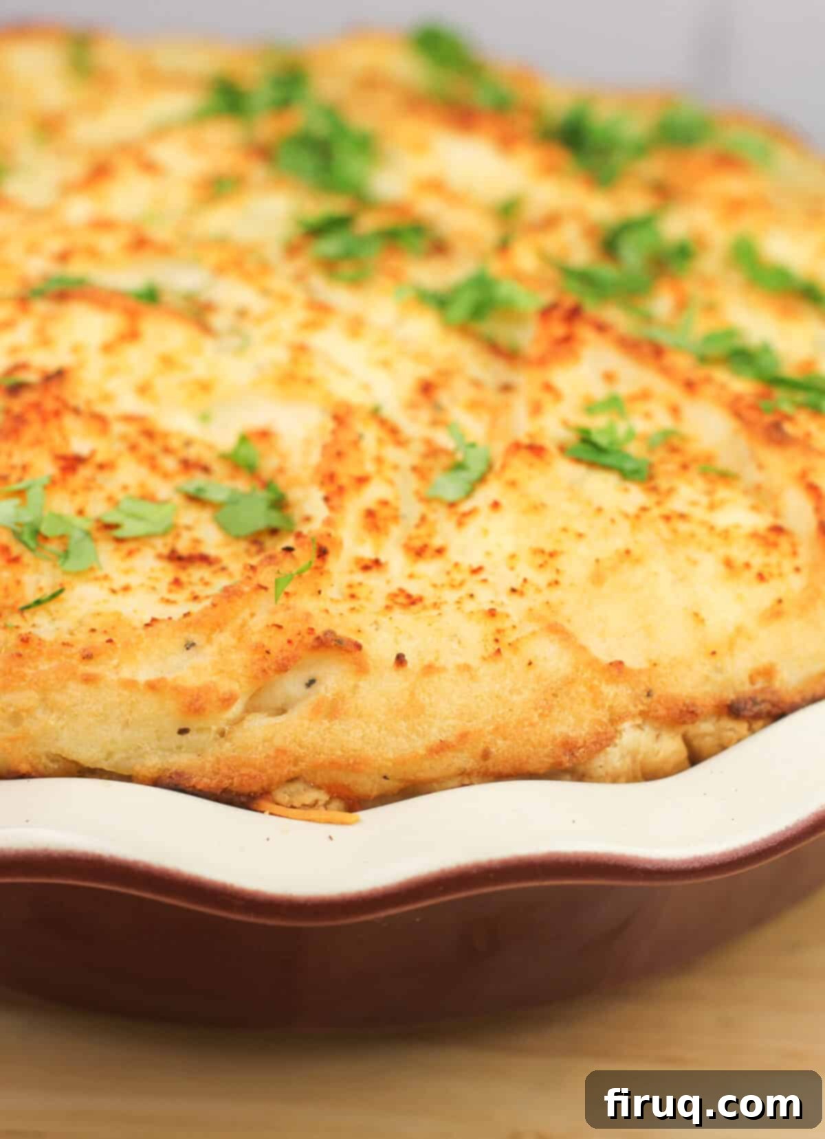 Ranchero Shepherds Pie 8 Prepared Mexican shepherd's pie in a pie plate, side view, showing layers and golden crust