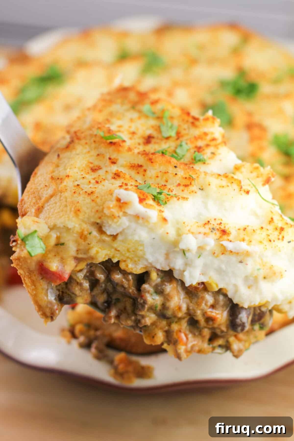 Ranchero Shepherds Pie 9 Spatula lifting a portion of prepared Mexican shepherd's pie