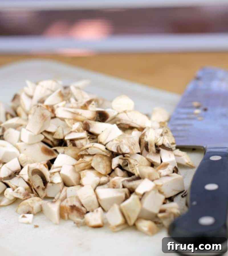 Gourmet Beef Stroganoff Crepes 4 chopped mushrooms on a white board