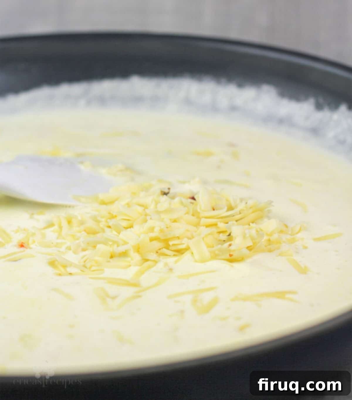 Baja Chicken Parmesan 8 cheese added to alfredo sauce in skillet