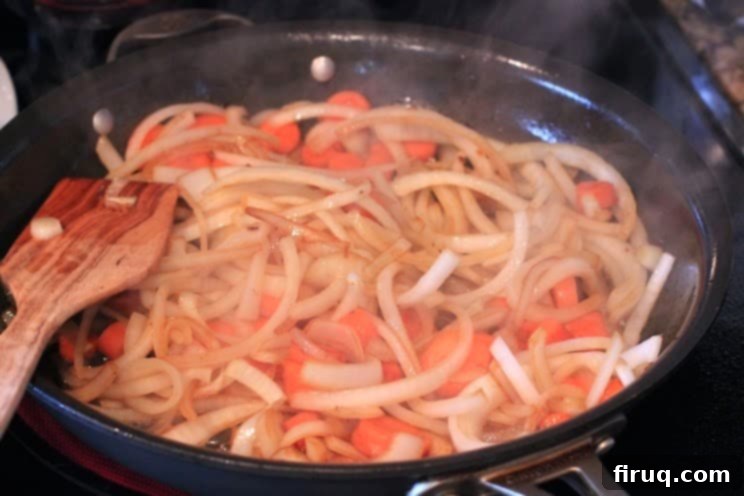 The Julia Child Boeuf Bourguignon 6 Sliced onions and carrots lightly browning in a skillet for Boeuf Bourguignon