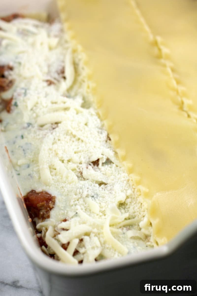 Classic Lasagna 11 view of the partially assembled classic lasagna ingredients, layer of pasta on half, then cheeses not yet covered