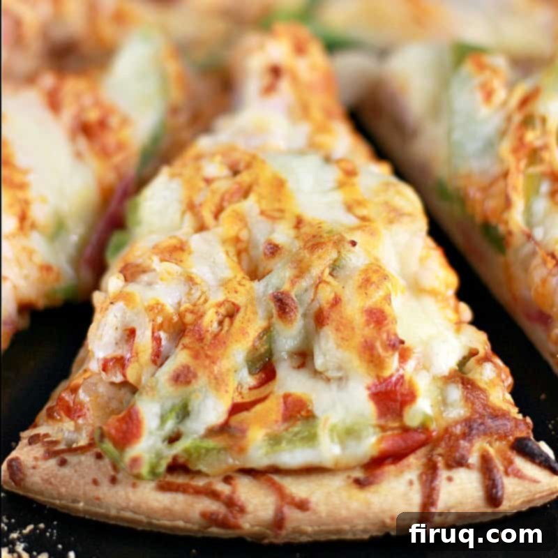 Spicy Buffalo Turkey Pizza 11 Top down angled view of a single slice of Buffalo Turkey Pizza, squared on view of a single slice from the crust towards the center of the pie. (zoomed in)