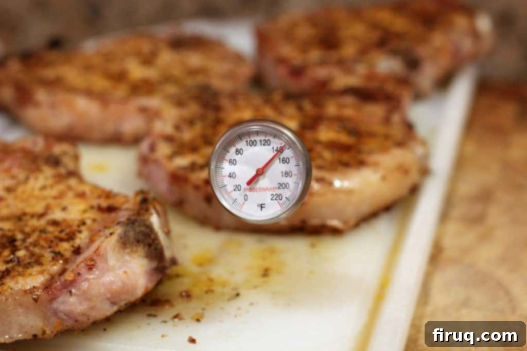 The Ultimate Grilled Pork Chops 3 Close-up of a juicy grilled pork chop with perfect sear marks