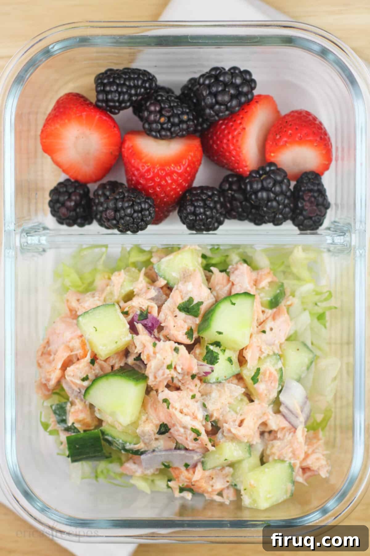 Meal Prep Salmon Salad 4 divided glass container with salmon salad in one section, berries in the other