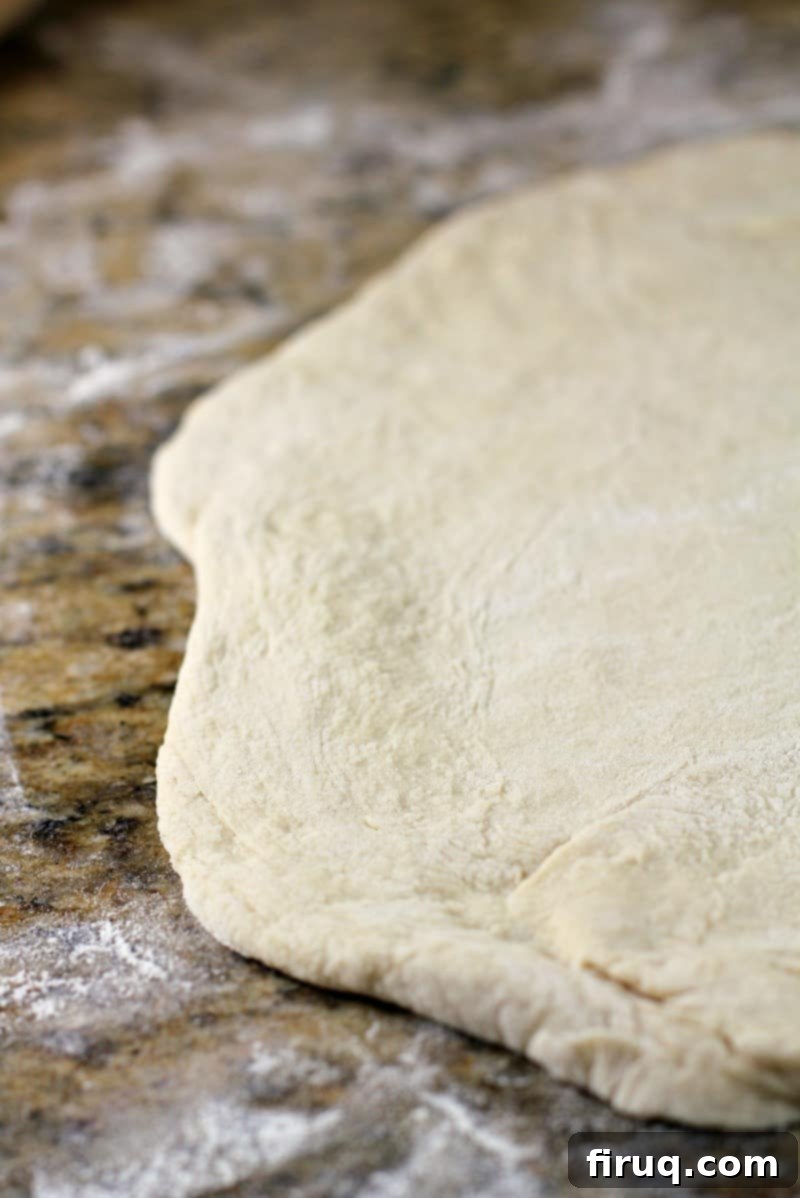 Sam Adams Hoppy Pizza Crust 11 rolled out dough on a granite surface