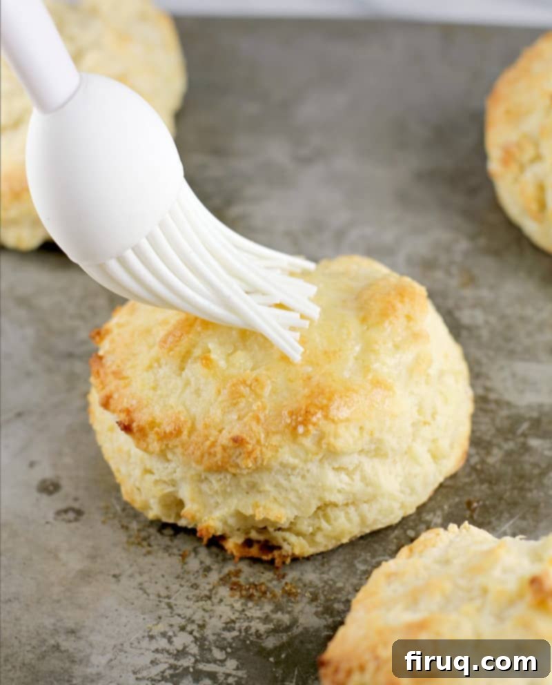 Fluffy Southern Buttermilk Biscuits 7 brush putting melted butter on a biscuit